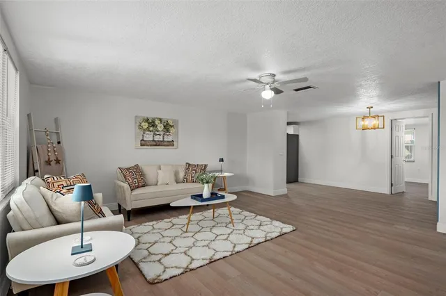 a living room with furniture and a chandelier