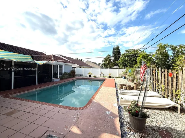 a view of a patio with couches chair and potted plants