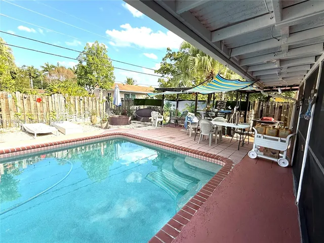 a view of a swimming pool with a patio