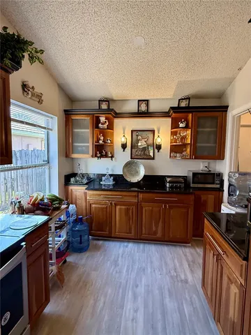 a kitchen with stainless steel appliances granite countertop a stove and a wooden floors
