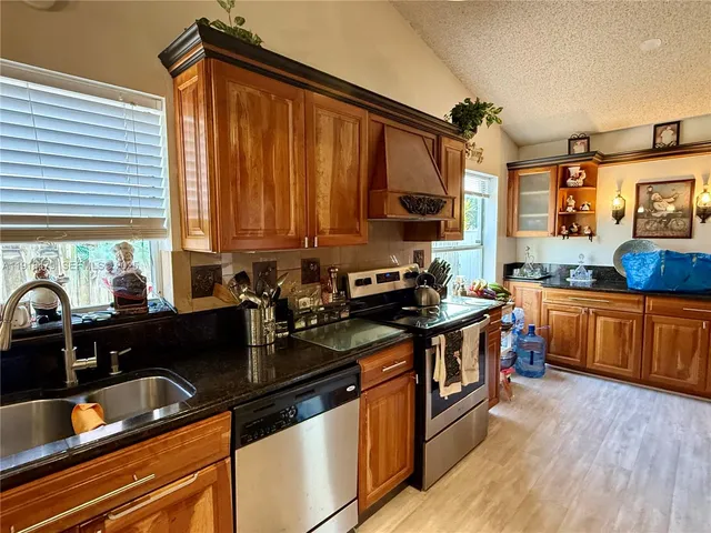 a kitchen with a sink stove and cabinets