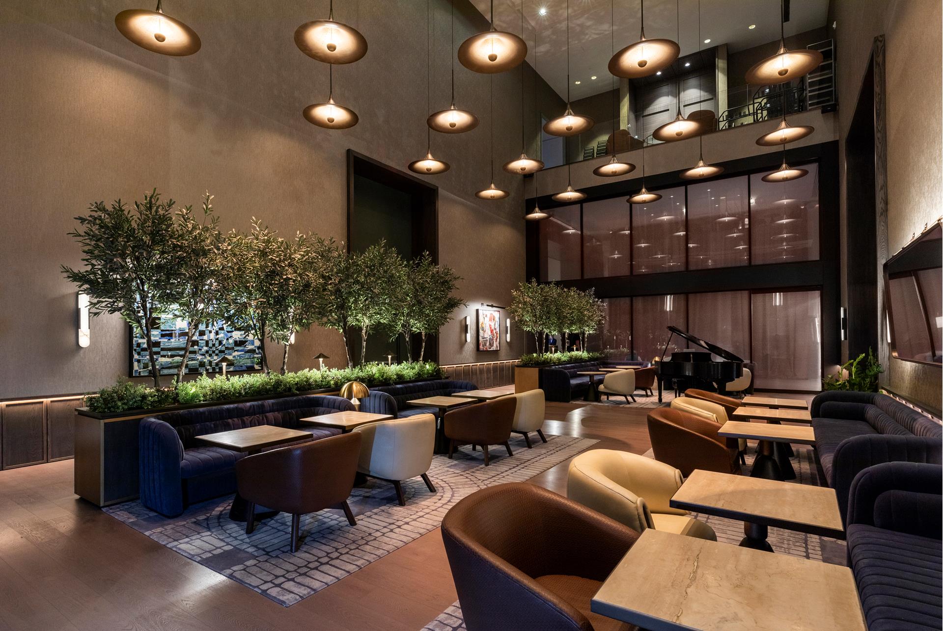 111 West 56th Street, Unit 41K Manhattan, NY 10019 - Photo 8 of 13 a living room with furniture a chandelier and a large window