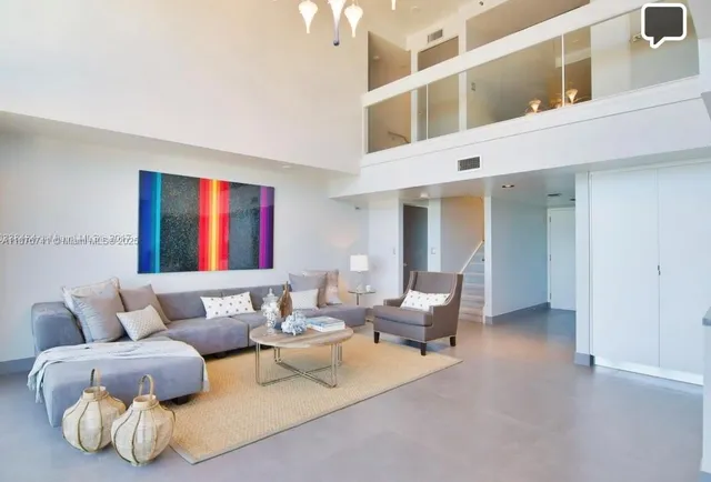 a living room with furniture and a ceiling fan