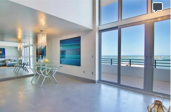 a view of a dining room with furniture window and outside view