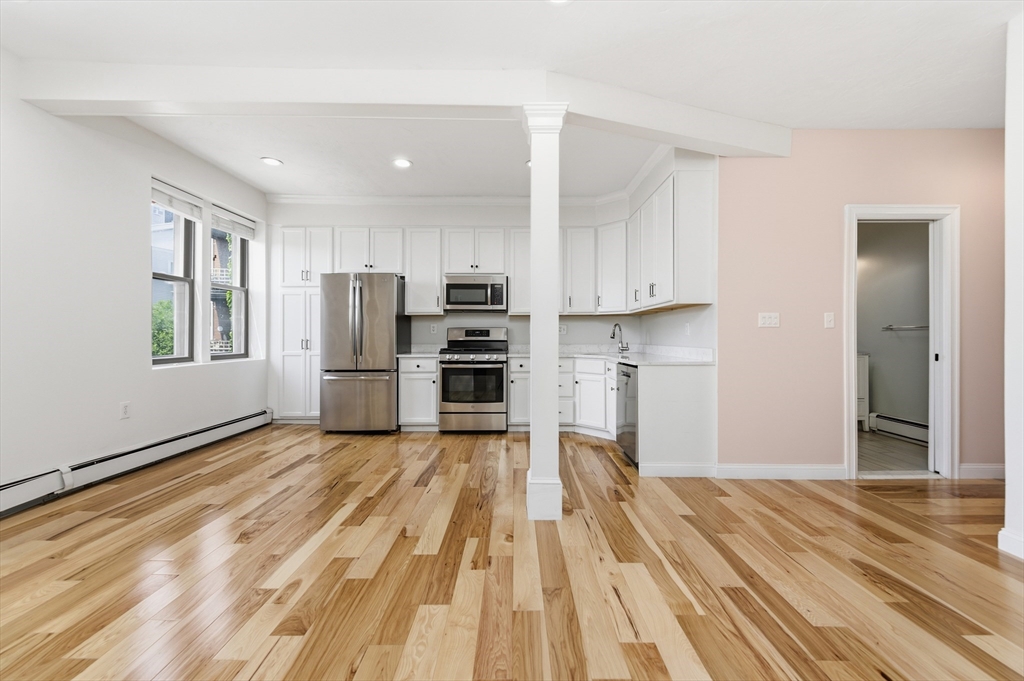 54 Beacon Street, Unit 2 Chelsea, MA 02150 - Photo 4 of 26 a view of kitchen with wooden floor and electronic appliances