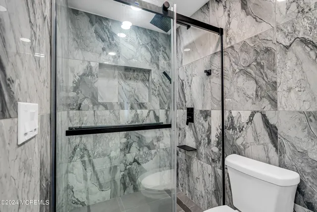 a bathroom with a toilet and shower