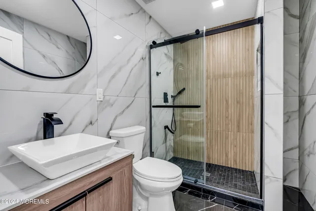 a bathroom with a toilet a sink and shower