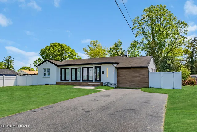a front view of a house with a yard and a garage