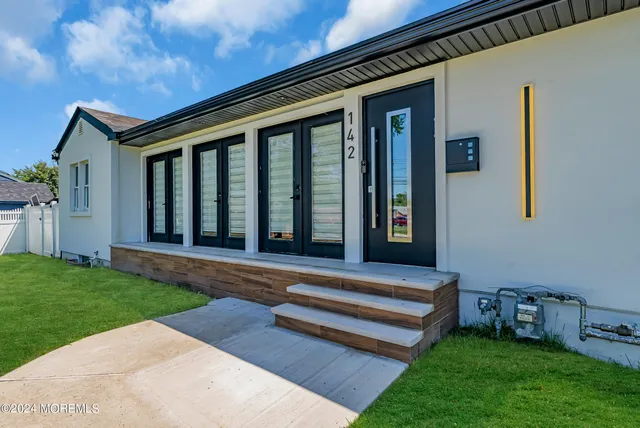 a view of a chair and table in backyard of the house