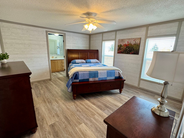 972 Ridgeway Loop, Unit 228 Garden City, UT 84028 - Photo 11 of 26 Master Bedroom featuring ceiling fan and connected bathroom
