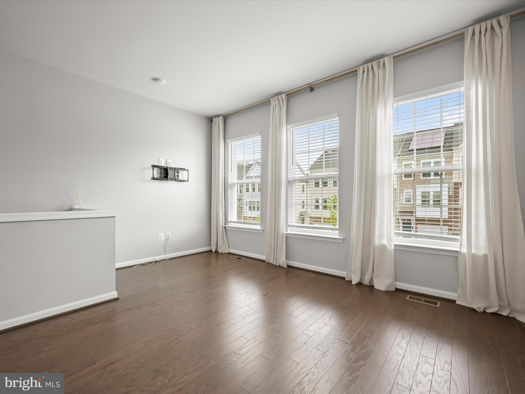 2612 Hardaway Circle Hanover, MD 21076 - Photo 5 of 29 an empty room with wooden floor and windows