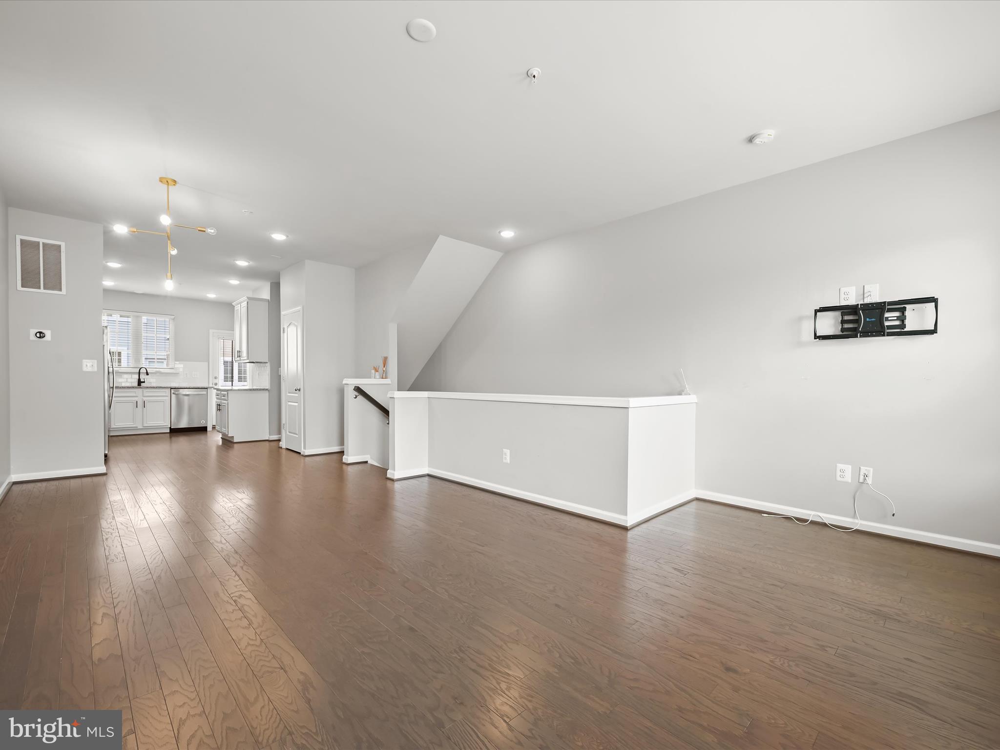 2612 Hardaway Circle Hanover, MD 21076 - Photo 7 of 29 a view of empty room with wooden floor and kitchen view