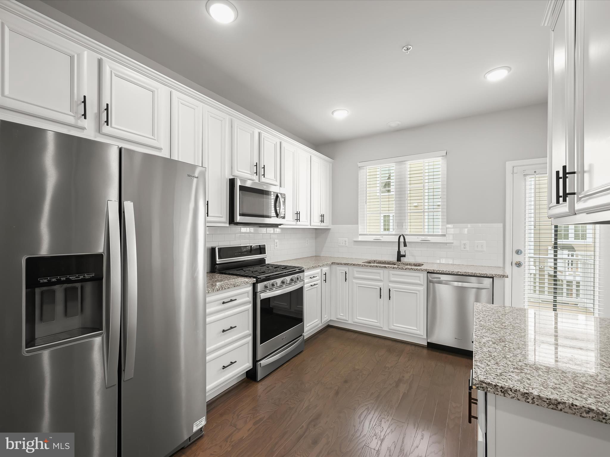 2612 Hardaway Circle Hanover, MD 21076 - Photo 9 of 29 a kitchen with stainless steel appliances granite countertop a refrigerator stove a sink and white cabinets
