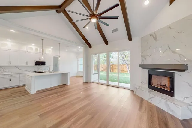 a open kitchen view with fireplace and wooden floor