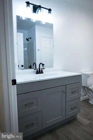 a bathroom with a sink vanity and mirror