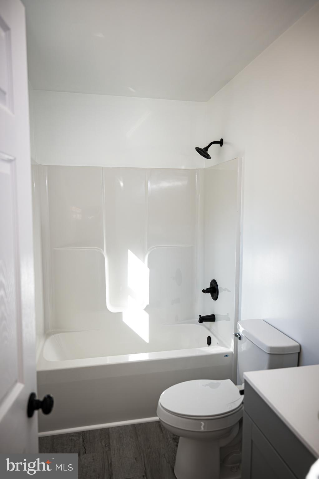 100 Bumpass Road Bumpass, VA 23024 - Photo 14 of 16 a bathroom with a bathtub and a toilet