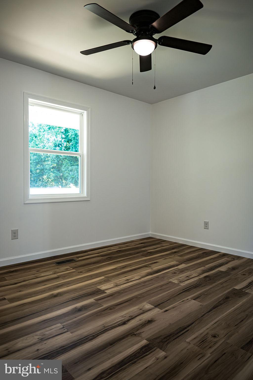 100 Bumpass Road Bumpass, VA 23024 - Photo 10 of 16 a view of an empty room with a window and wooden floor