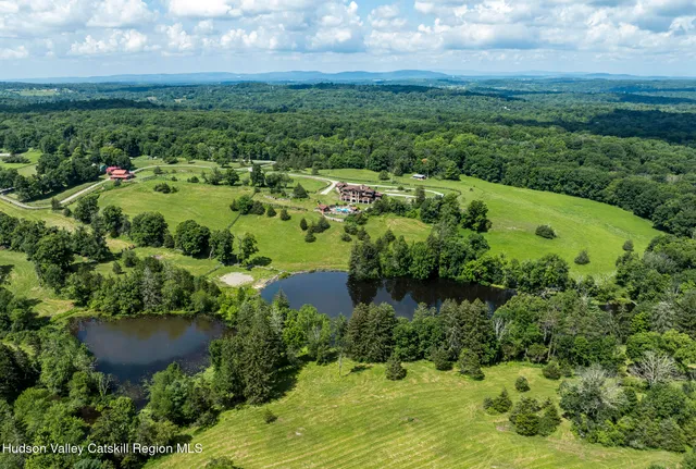 a living room with fireplace furniture and a rug