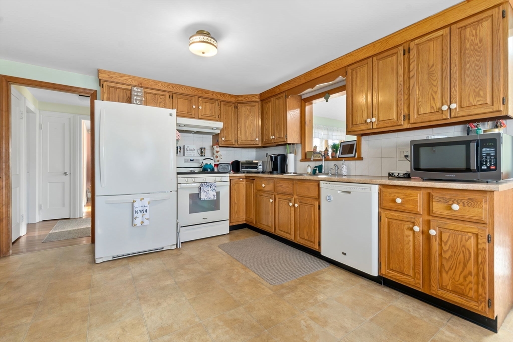 33 Proctor Circle Peabody, MA 01960 - Photo 12 of 42 a kitchen with stainless steel appliances a refrigerator sink and cabinets