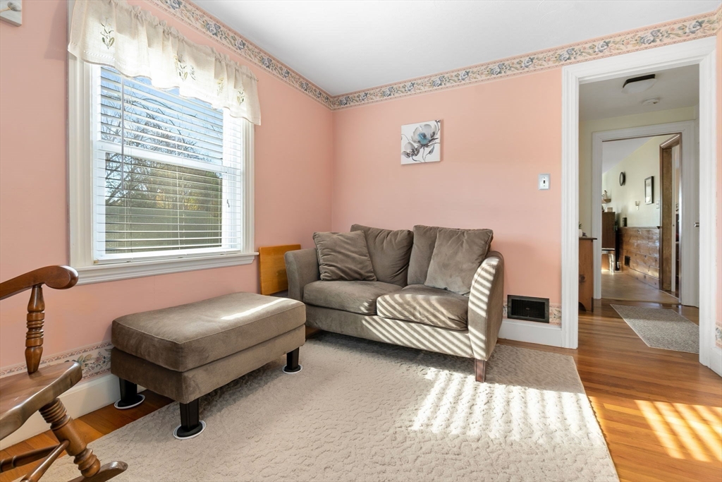 33 Proctor Circle Peabody, MA 01960 - Photo 22 of 42 a living room with a couch and a dresser next to a window