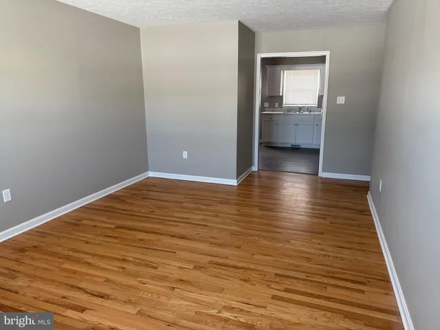 a view of room with wooden floor and cabinet