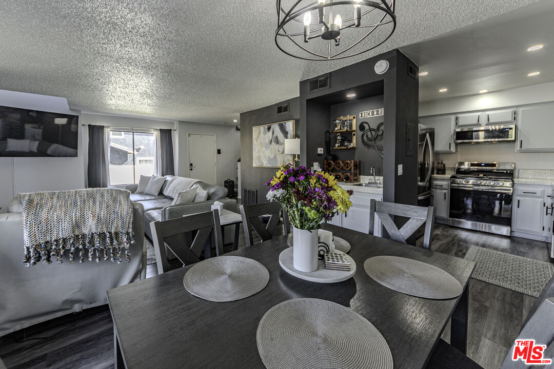 849 East Victoria Street, Unit 101 Carson, CA 90746 - Photo 1 of 19 a view of a dining room with furniture window and wooden floor
