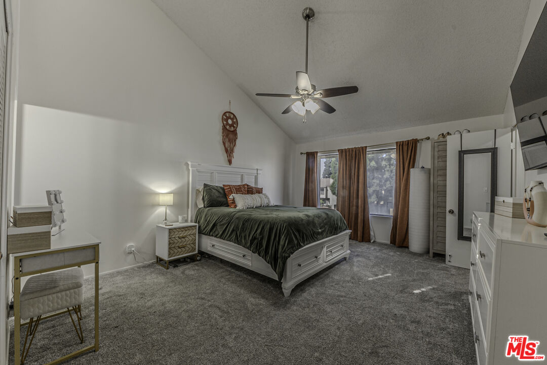 849 East Victoria Street, Unit 101 Carson, CA 90746 - Photo 12 of 19 a spacious bedroom with a bed and a table