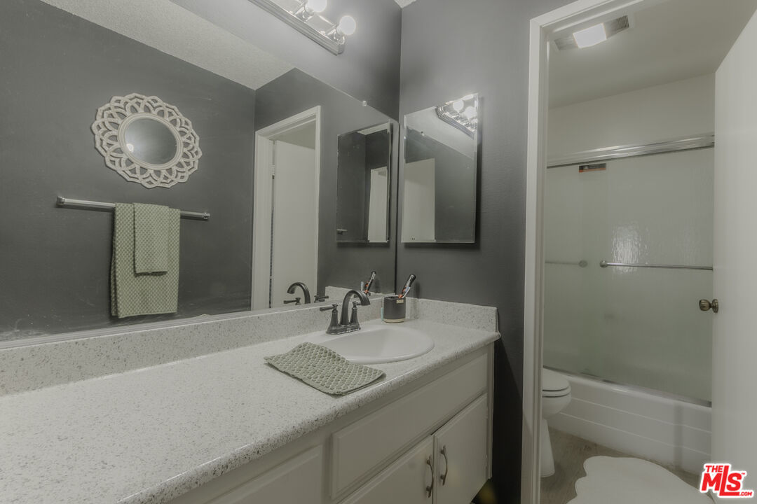 849 East Victoria Street, Unit 101 Carson, CA 90746 - Photo 13 of 19 a bathroom with a sink a toilet and a mirror