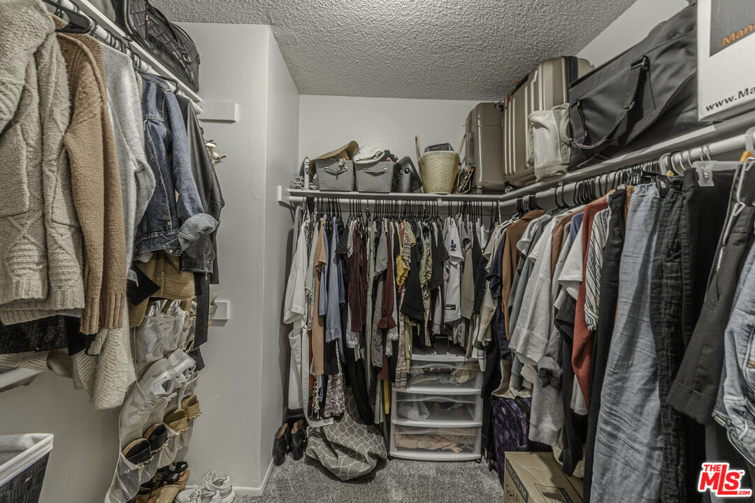 849 East Victoria Street, Unit 101 Carson, CA 90746 - Photo 14 of 19 a view of walk in closet with clothes