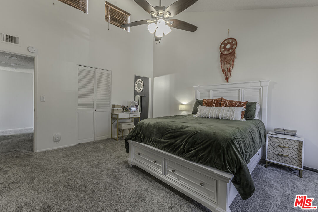 849 East Victoria Street, Unit 101 Carson, CA 90746 - Photo 15 of 19 a bedroom with a bed and a chandelier