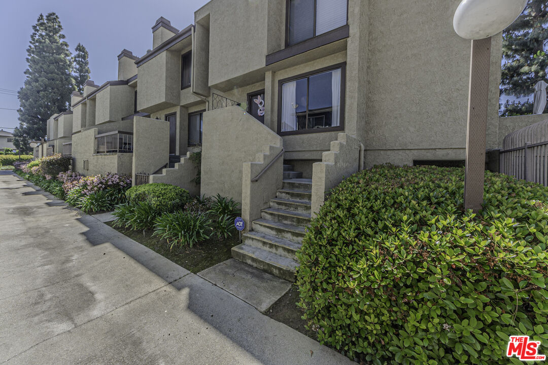 849 East Victoria Street, Unit 101 Carson, CA 90746 - Photo 19 of 19 a front view of a house with a yard