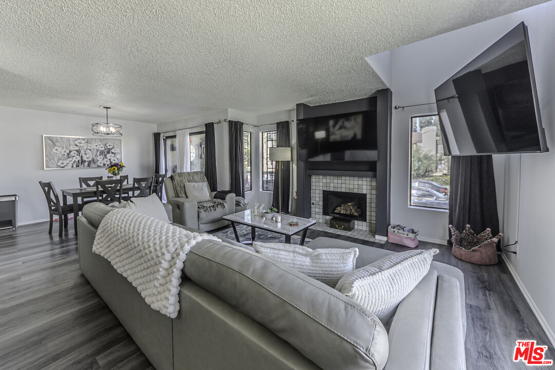 849 East Victoria Street, Unit 101 Carson, CA 90746 - Photo 2 of 19 a living room with furniture fireplace and flat screen tv