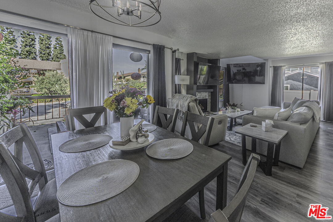 849 East Victoria Street, Unit 101 Carson, CA 90746 - Photo 5 of 19 a dining room with furniture a large window and dining table