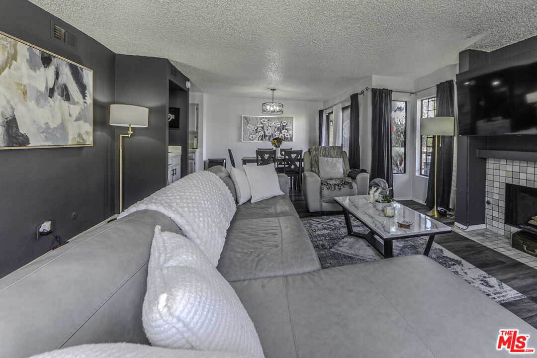 849 East Victoria Street, Unit 101 Carson, CA 90746 - Photo 8 of 19 a living room with furniture and a flat screen tv