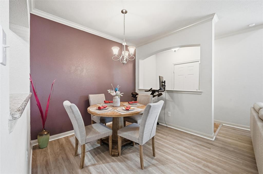 6913 Sandshell Boulevard Fort Worth, TX 76137 - Photo 16 of 24 a view of a dining room with furniture and wooden floor