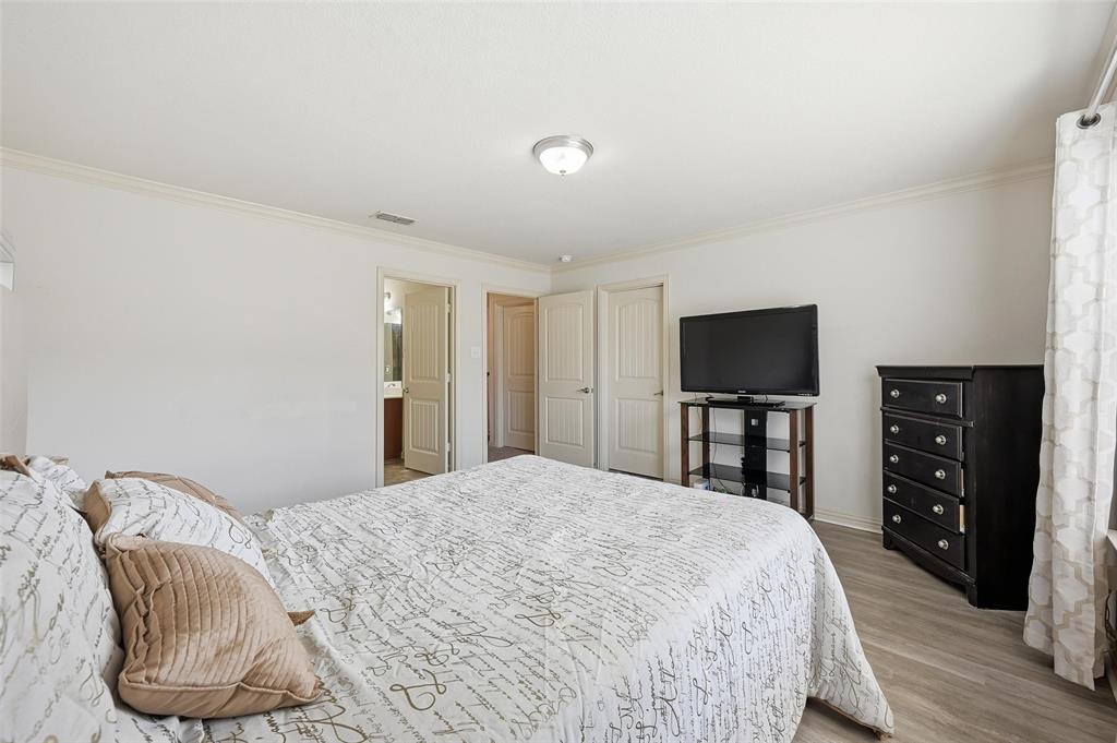 6913 Sandshell Boulevard Fort Worth, TX 76137 - Photo 5 of 24 a bedroom with a bed and a television