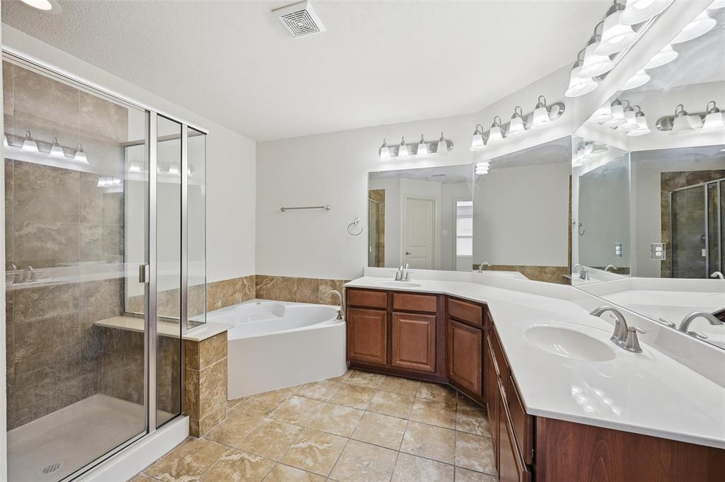 6913 Sandshell Boulevard Fort Worth, TX 76137 - Photo 6 of 24 a bathroom with a tub a sink shower and mirror