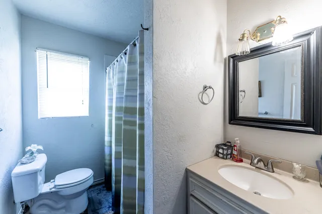 a bathroom with a sink toilet and mirror