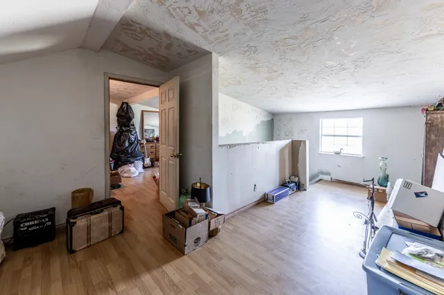 a view of a workspace with furniture and wooden floor