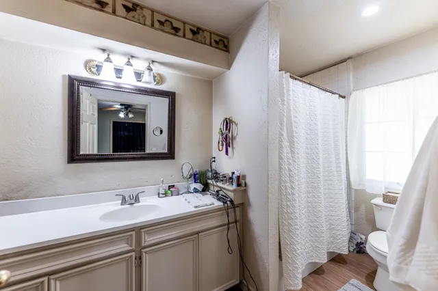 a bathroom with a sink vanity and a mirror