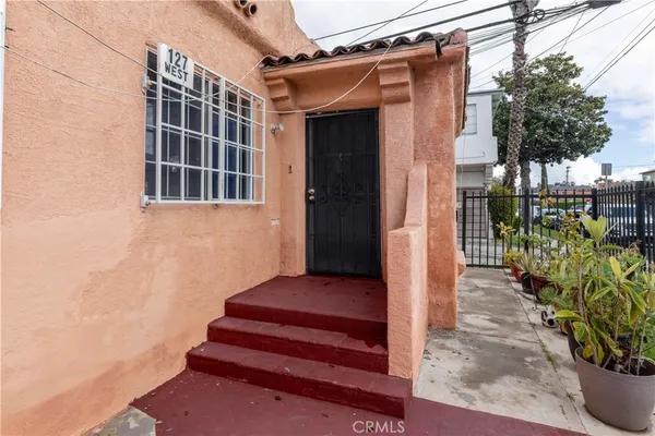 a view of a porch with potted plants