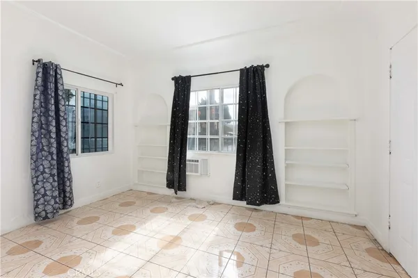 a view of an empty room with windows