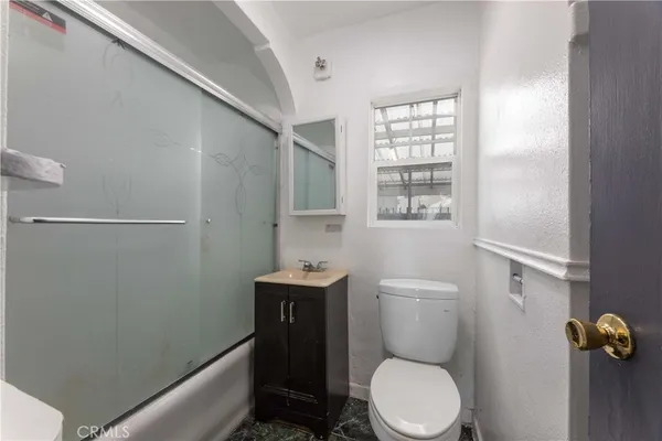 a white toilet sitting next to a bathroom sink