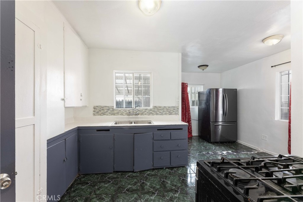 2000 Pacific Long Beach, CA 90806 - Photo 27 of 51 a kitchen with stainless steel appliances granite countertop a sink stove and refrigerator