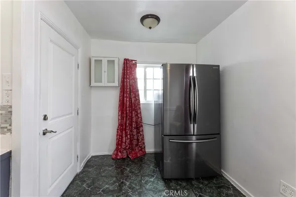 a kitchen with stainless steel appliances a refrigerator and a stove