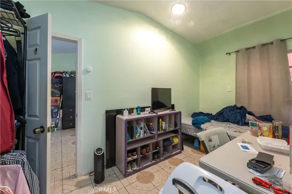 a living room with furniture a flat screen tv and a window