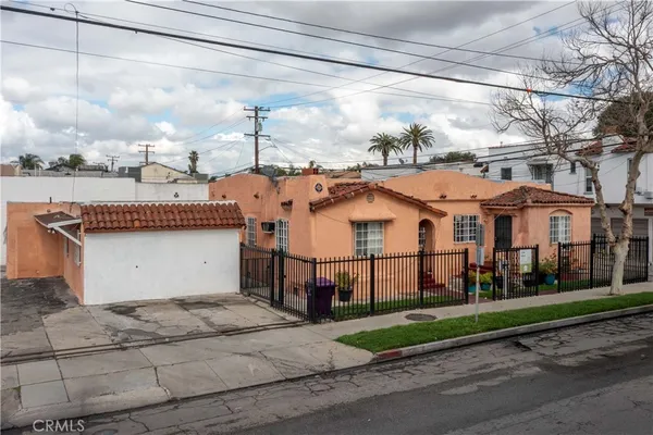a view of a white house with a street