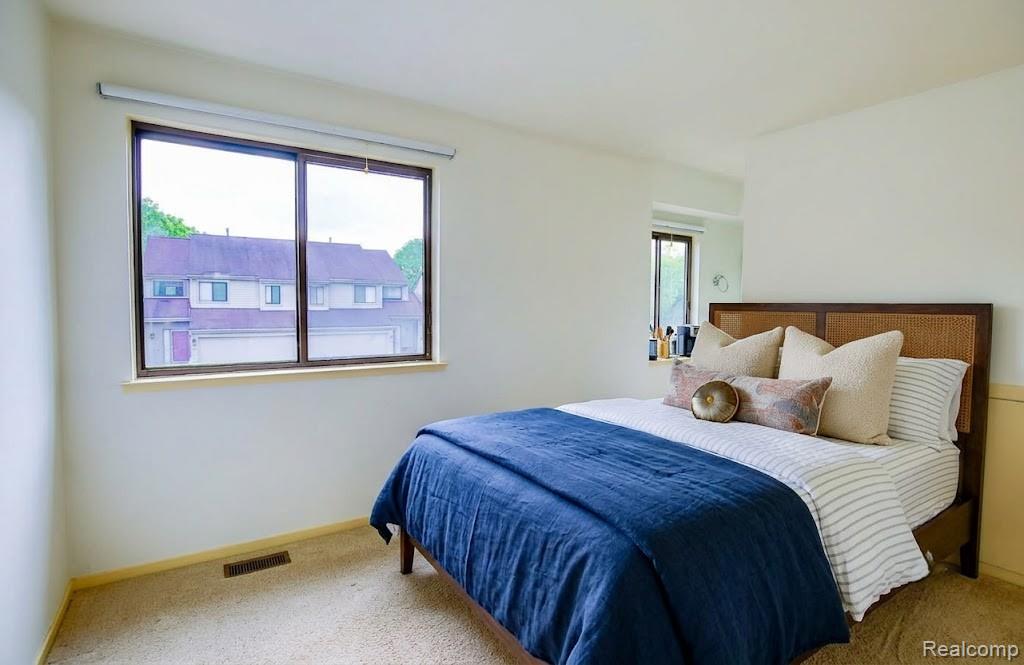 716 Eton Court Rochester, MI 48307 - Photo 17 of 41 2nd bedroom window with a roller shade, light-toned wall paint, and carpeted flooring