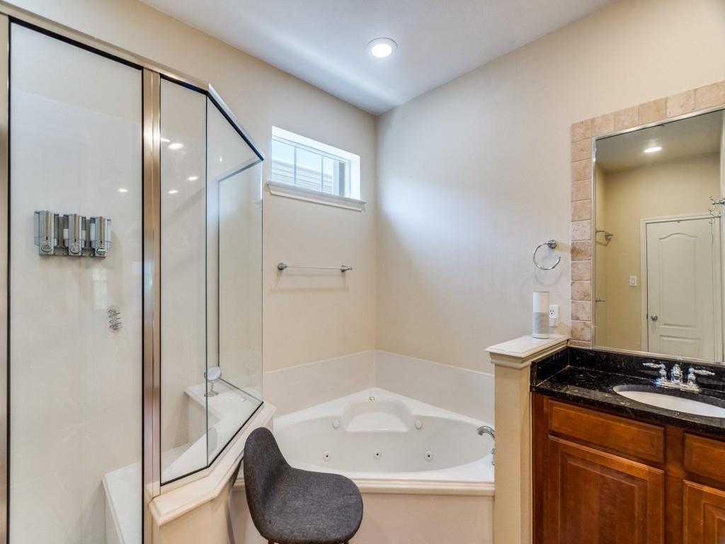 15711 Spectrum Drive, Unit 80 Addison, TX 75001 - Photo 21 of 26 a bathroom with a granite countertop sink and a mirror