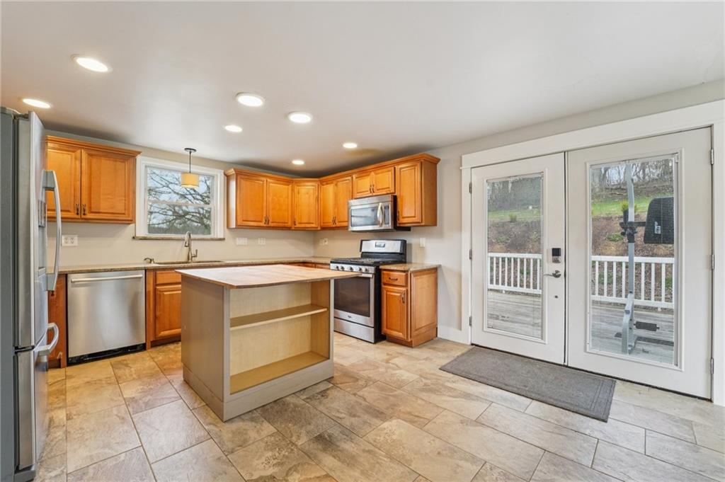 6012 Cunningham Road Gibsonia, PA 15044 - Photo 9 of 26 a kitchen with stainless steel appliances granite countertop a stove a sink and a refrigerator